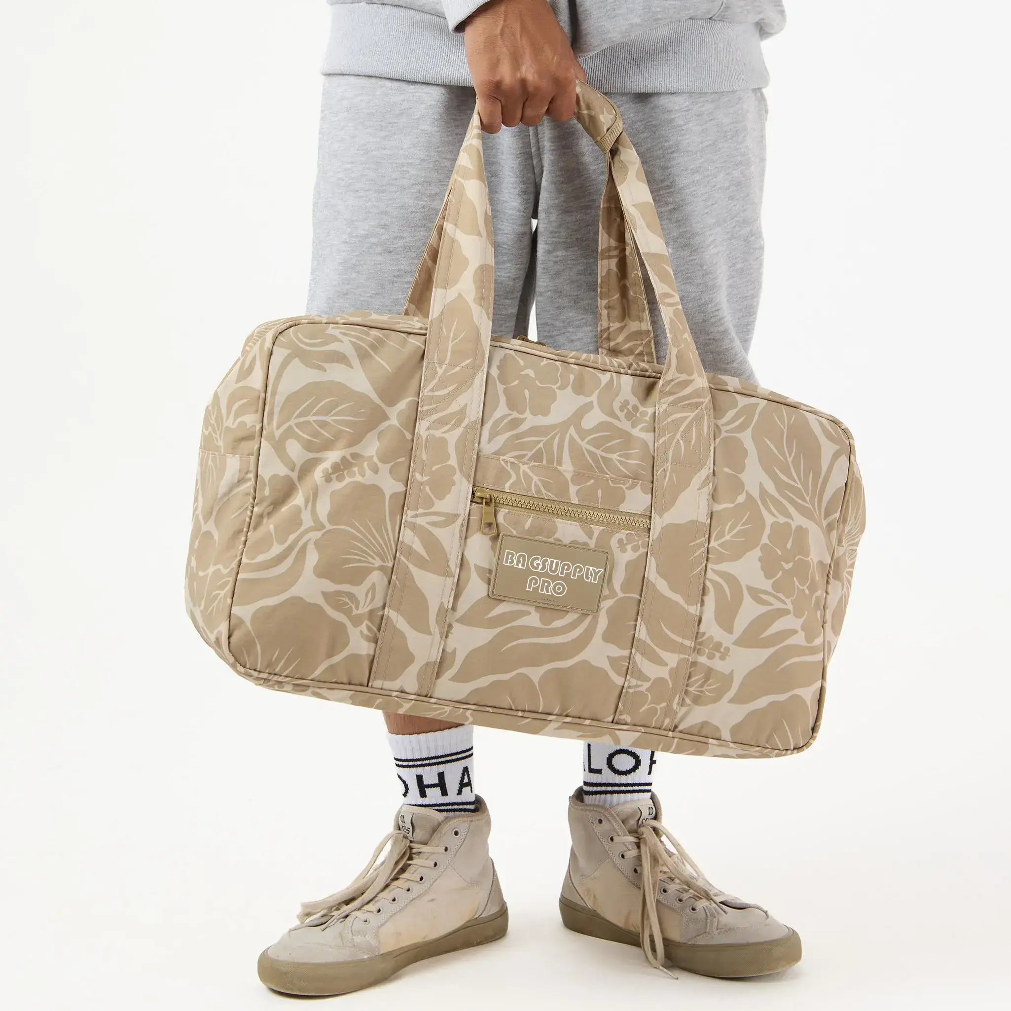 A customizable, portable tyvek travel tote bag with a floral print, perfect for seaside trips. The bag is designed to be both durable and fashionable, with a spacious interior for all your travel needs