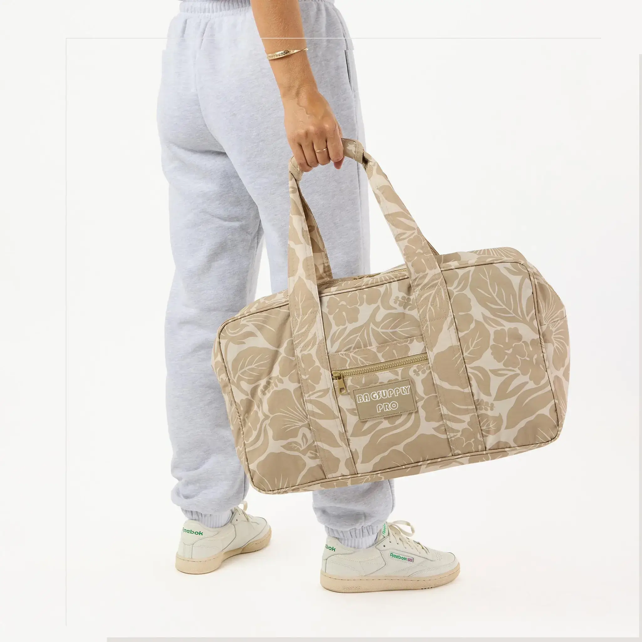 A waterproof, large tyvek travel tote bag with a full floral design, ideal for beach trips. The bag offers ample storage space and is designed to be both practical and stylish for your seaside adventures